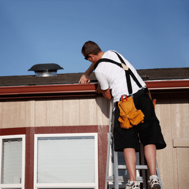Professional Installing Seamless Gutters on Home